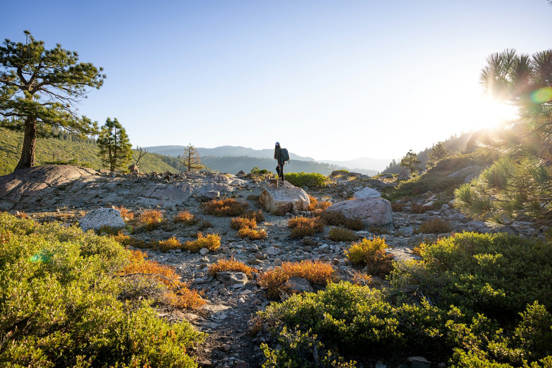 Hiker on a mountain path at sunrise